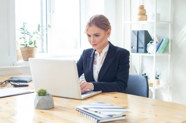 Business and people concept. Business woman with laptop computer working at office