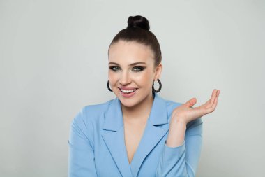 Happy gesturing smiling young woman on white background with copyspace