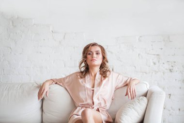 Confident woman posing indoor at home