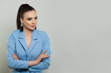Beautiful model woman with crossed arms looking aside on grey banner background with copy space