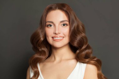 Close-up portrait of attractive lovely gorgeous wavy-haired woman on dark grey color background