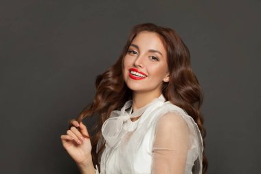 Vogue style close-up portrait of beautiful woman with long curly hair