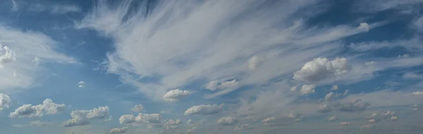 White clouds in blue sky, horizon background