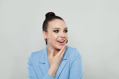 Surprised happy brunette woman with cute smile and trendy makeup looking away over white background