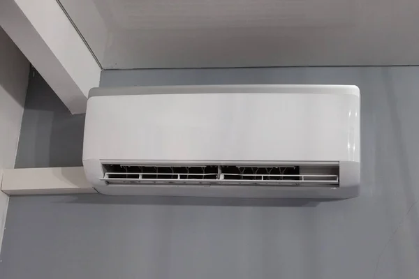 Air conditioner on gray wall room interior background