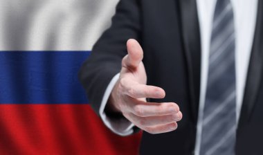 Russian business, politics, cooperation and travel concept. Hand on flag of Russia background.