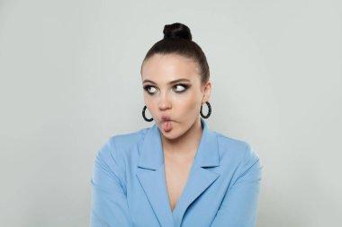 Young beautiful woman making fish face with lips, crazy and comical gesture. Funny facial expression.