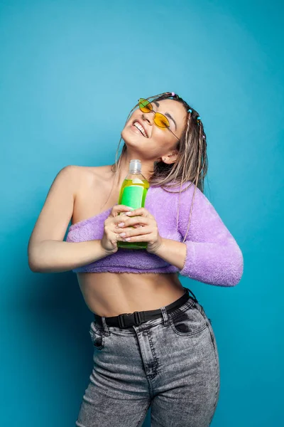 Happy Excited Smiling Holding Green Plastic Bottle Blue Studio Wall — Stock Photo, Image