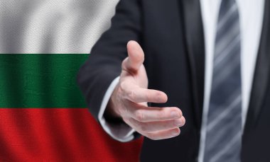 Welcome to the Bulgaria. Hand on Bulgarian flag background. Business, politics, cooperation and travel concept