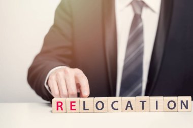 Relocation concept. Man pointing at relocation inscription