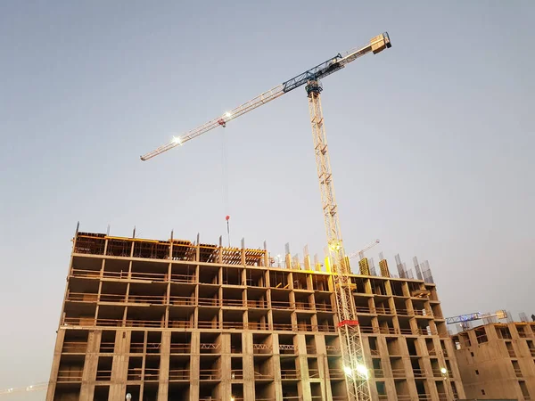 Building crane and construction site under sky