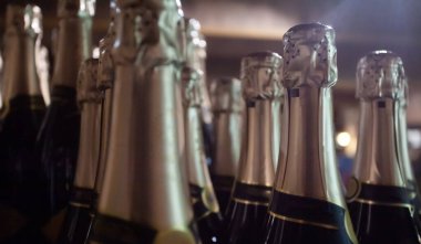 Bottles of sparkling wine with golden bottleneck