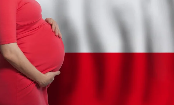 Pregnant woman belly on Polish flag background