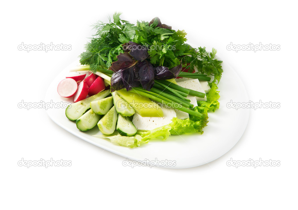 Plate of salad include lettuce, basil, parsley, cucumber, feta cheese, radish, on the white background