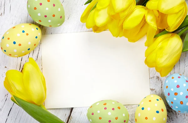 Easter eggs, tulips and card — Stock Photo, Image