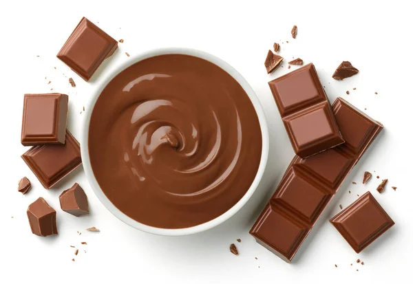 Bowl of melted milk chocolate and broken pieces of chocolate bar isolated on white background, top view