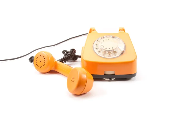 Оранжевый ретро-телефон — стоковое фото