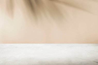 Krema duvarında tropik palmiye ağacı gölgesi ve lüks mermer masa 