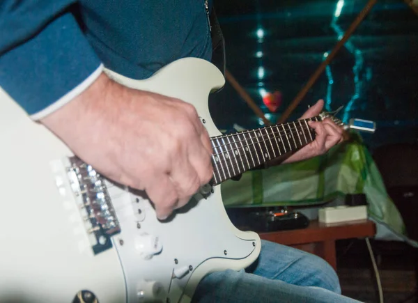 Een Man Speelt Een Witte Elektrische Gitaar — Stockfoto