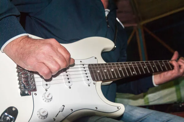 Een Man Speelt Een Witte Elektrische Gitaar — Stockfoto