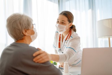 Coronavirus ve grip salgını sırasında maske takan doktor ve son sınıf öğrencisi. Virüs koruması. COVID-2019. Maske takıyor.