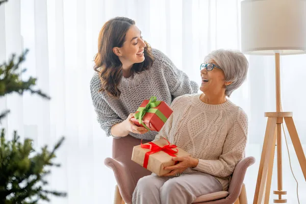 Merry Christmas Happy Holidays Senior Mom Her Adult Daughter Exchanging — Stock Photo, Image
