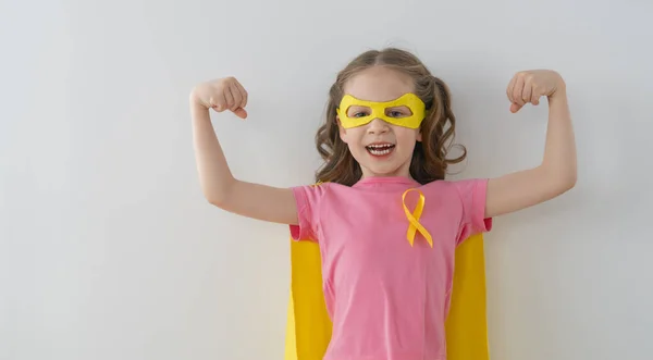 World Childhood Cancer Day Girl Superhero Costume Golden Ribbon — Stock Photo, Image