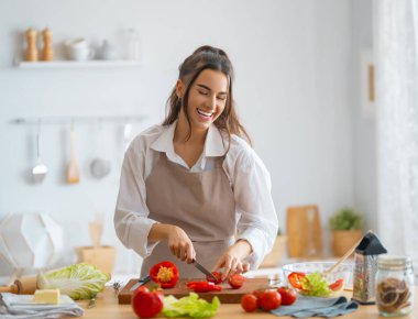 Evde sağlıklı yiyecekler. Kadın mutfakta doğru düzgün bir yemek hazırlıyor..