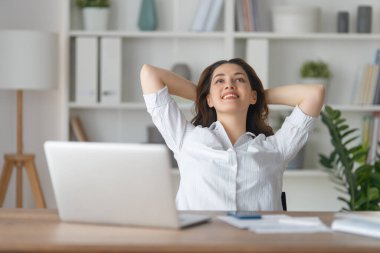 Ofiste dizüstü bilgisayarla çalışan konsantre bir kadın..
