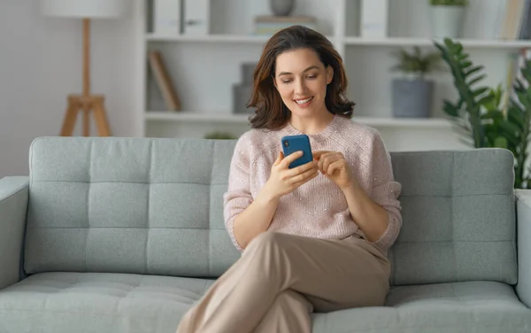Happy Casual Beautiful Woman Using Phone Sitting Sofa Home — Stock Photo, Image