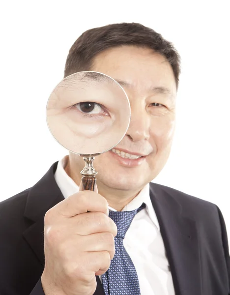 Businessman looking a magnifying glass — Stock Photo, Image