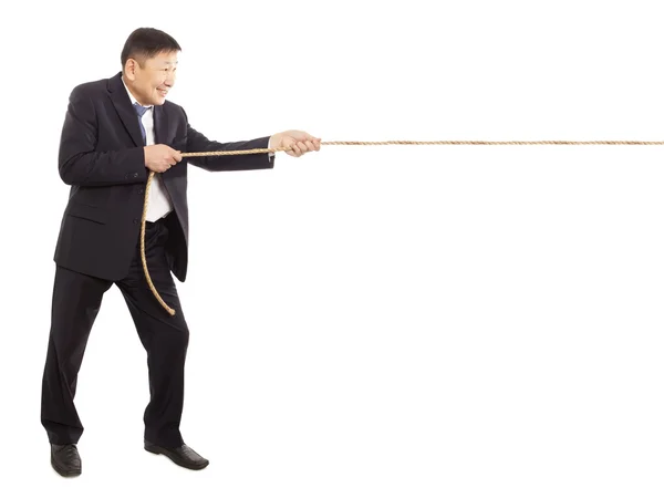 Asian businessman pulling a rope — Stock Photo, Image