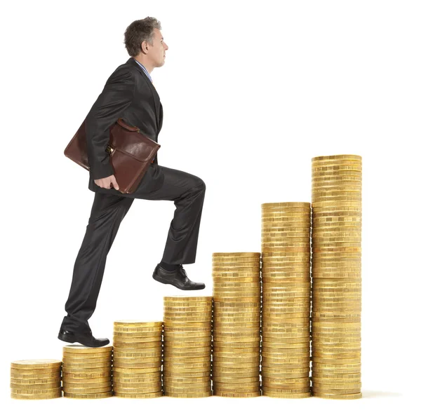 Businessman goes up gold coins — Stock Photo, Image