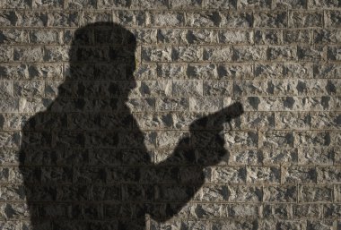 Human silhouette with handgun clipart