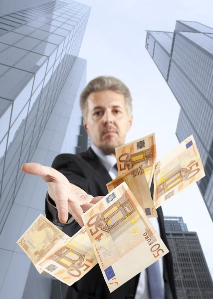 Businessman throwing euro — Stock Photo, Image