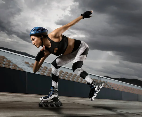 Professional beautiful woman roller skating. Concept of sport, movement, energy, dynamic, healthy lifestyle