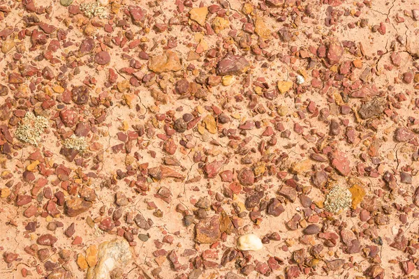 Structure of red clay with rocks — Stock Photo, Image