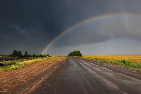 Rainbow over road — Stock Photo, Image