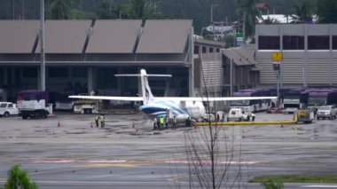 Airport staff inspecting the plane