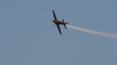 Yellow plane in the blue sky