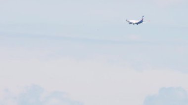NOVOSIBIRSK, RUSSIAN FEDERATION - JUNE 27, 2021: Long shot of aircraft Boeing 737 of Aeroflot airlines approaching before landing to Tolmachevo international airport, Novosibirsk OVB. Tourism and