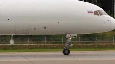 MOSCOW, RUSSIAN FEDERATION - JULY 28, 2021: Footage of a cargo plane without livery taxiing from left to right. Side view of Cargo Boeing 757 E-Cargo Airlines taxis to the runway at Sheremetyevo