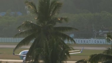 PHUKET, THAILAND - NOVEMBER 27, 2019: Boeing 737 Nok Air speeding up before takeoff from Phuket airport, Thailand in the early morning at dawn. Tourism and travel concept, air flight