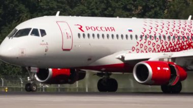 MOSCOW, RUSSIAN FEDERATION - JULY 29, 2021: Middle shot of Sukhoi Superjet Rossiya taxiing along the runway to the terminal after landing at the Sheremetyevo Airport, Moscow SVO. Narrow-body