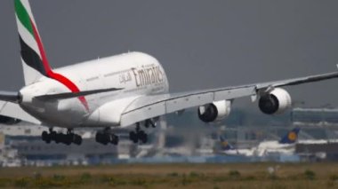 FRANKFURT AM MAIN, GERMANY - JULY 18, 2017: Huge double-deck airliner Airbus A380 of Emirates landing at Frankfurt airport, Germany. Tourism and travel concept, air flight