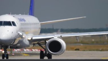 FRANKFURT AM MAIN, GERMANY - JULY 18, 2017: Embraer E190LR, D-AECF of Lufthansa CityLine taxiing to the runway before takeoff at Frankfurt Airport, Germany. Medium shot, aircraft on taxiway, side view