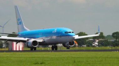 AMSTERDAM, THE NETHERLANDS - JULY 26, 2017: Middle shot of civil airplane Boeing 737 KLM Airlines landing at Schiphol Airport, Amsterdam AMS. Tourism and travel concept.
