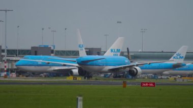 AMSTERDAM, THE NETHERLANDS - JULY 27, 2017: Schiphol airport airfield, Amsterdam. Airplanes of KLM airlines on the taxiways against the background of the terminal. KLM Dutch airline