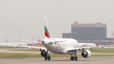 MOSCOW, RUSSIAN FEDERATION - JULY 28, 2021: Back view of passenger Airbus A319 Bulgaria Air taxiing on the runway before takeoff at Sheremetyevo Airport. Airport traffic, departure area