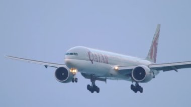 PHUKET, THAILAND - NOVEMBER 27, 2019: Passenger plane Boeing 777 Qatar Airways approaching to land at Phuket airport. Tourism and travel concept, air flight